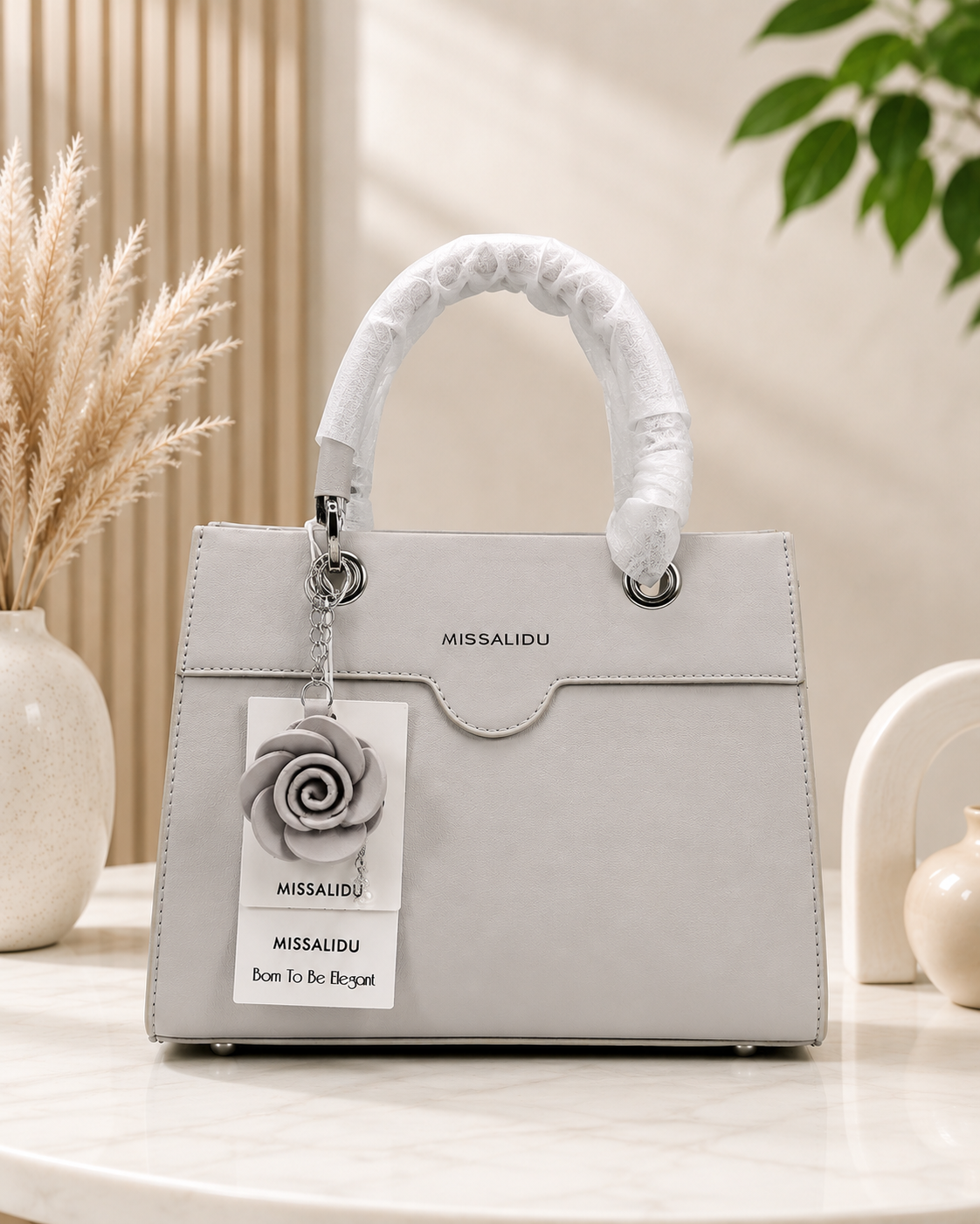 Elegant Structured Handbag with Floral Keychain