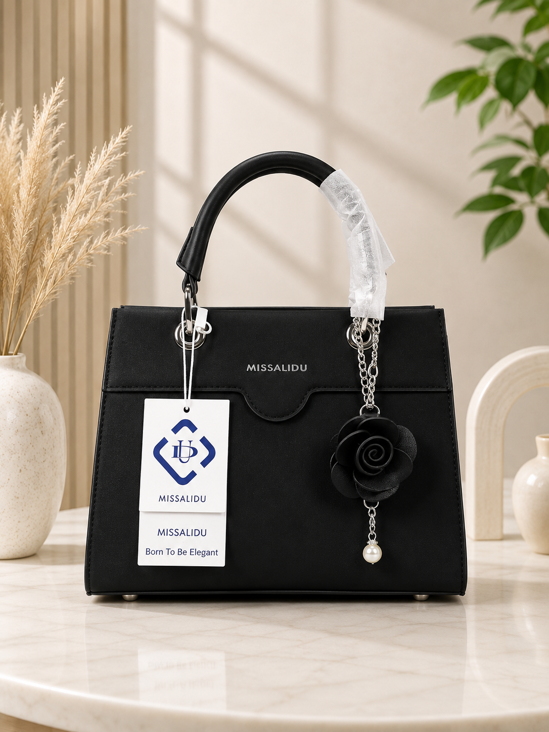 Elegant Structured Handbag with Floral Keychain